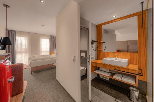 a bathroom with a sink and a mirror at Zündwerk - Motel in Strasshof an der Nordbahn