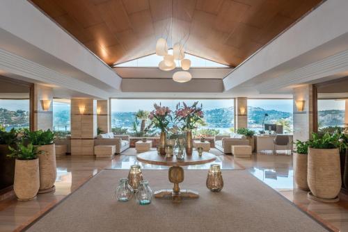a large lobby with a table with glasses and flowers at Iberostar Selection Jardín del Sol Suites - Adults Only in Santa Ponsa