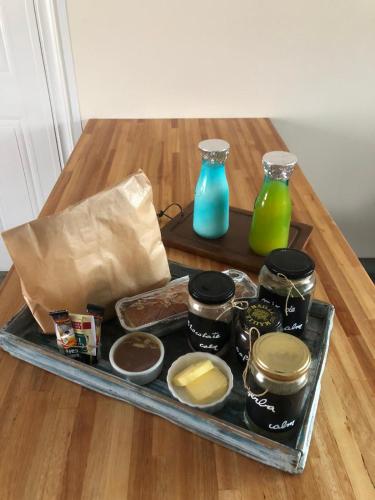 a tray of food on a table with two vases at Calm in Carmelo