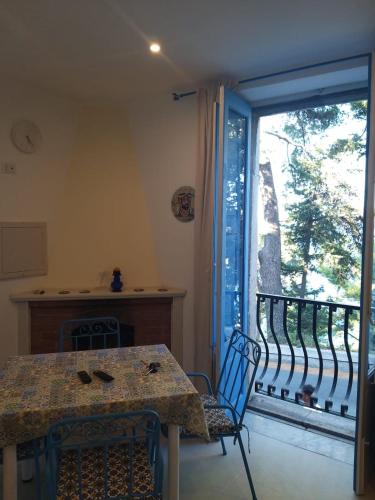 a dining room with a table and a large window at ToviMar Apartments in Taormina