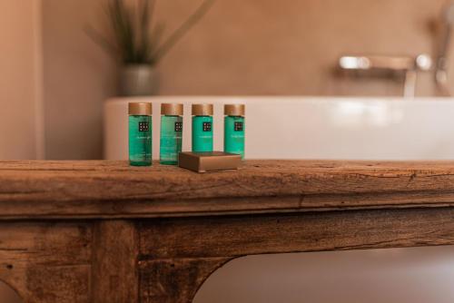 a group of three tubes of toothpaste on a wooden table at B&B Maison Lize in Lievegem