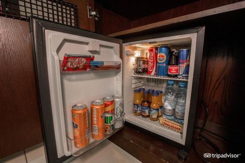 an open refrigerator filled with drinks and sodas at Mark Inn Hotel Deira in Dubai