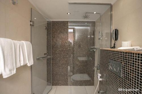 a bathroom with a shower with a glass door at Mark Inn Hotel Deira in Dubai