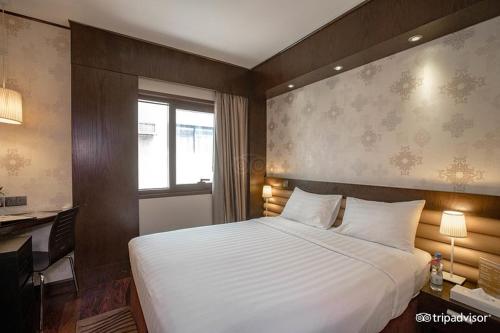 a bedroom with a large white bed and a window at Mark Inn Hotel Deira in Dubai
