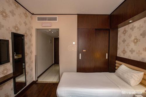 a bedroom with a bed and a tv in it at Mark Inn Hotel Deira in Dubai
