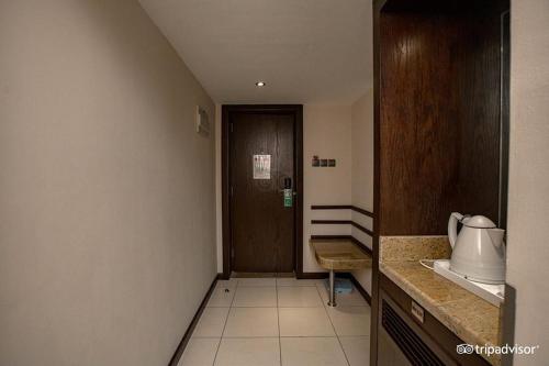 a room with a hallway with a door and a kitchen at Mark Inn Hotel Deira in Dubai
