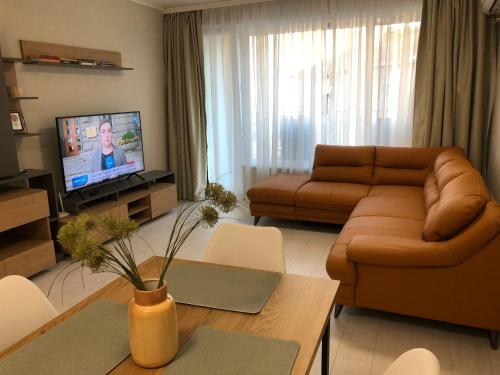 a living room with a couch and a table at RELAX Apartments in HASKOVO, Apt2 in Haskovo