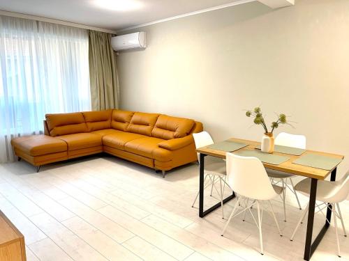 a living room with a couch and a table at RELAX Apartments in HASKOVO, Apt2 in Haskovo