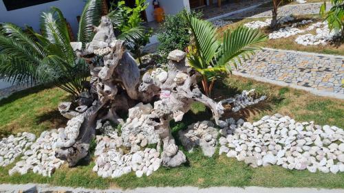 a rock garden with a tree and a pile of rocks at Babas Guesthouse in Moalboal