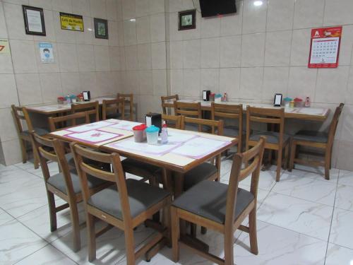 a dining room with wooden tables and chairs at Teodoro Palace Hotel a 5 minutos do Brás e Bom Retiro in Sao Paulo