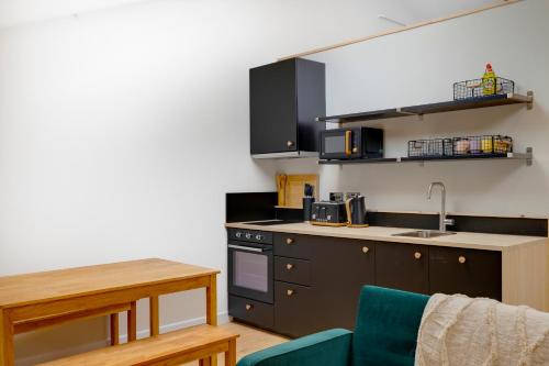 a kitchen with a sink and a stove top oven at CoalShed Lofts - Groups -Exclusive Use in Bristol