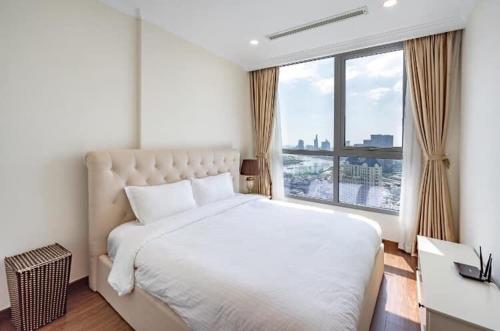 a bedroom with a large bed and a large window at Landmark 81 Luxury Condotel in Ho Chi Minh City