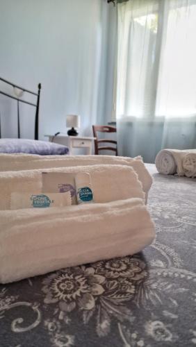 a pile of towels sitting on top of a bed at Casa della Zagara in Acireale