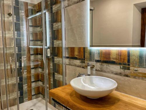 a bathroom with a white sink and a mirror at Il Gaudente B&B in Santa Fiora
