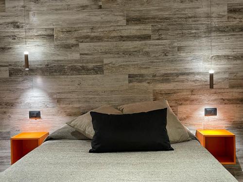 a bedroom with a bed with two end tables at Il Gaudente B&B in Santa Fiora