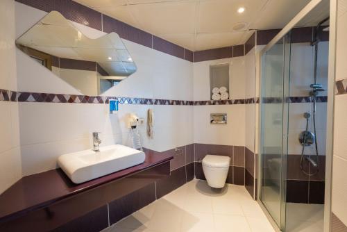 a bathroom with a sink and a shower at Hotel Caprea in Marmaris