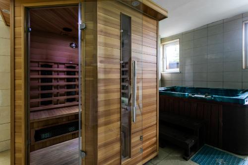 a bathroom with a shower and a tub in a room at MADOHORA ŚLEMIEŃ in Kocoń