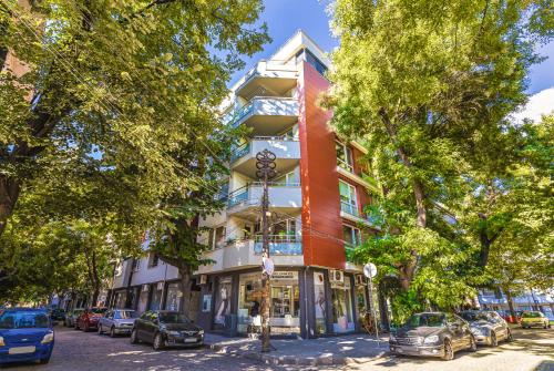a building on a street with cars parked in front of it at Stylish 2BD Apartment with a Nice Cozy Terrace by Flat Mаnager in Plovdiv