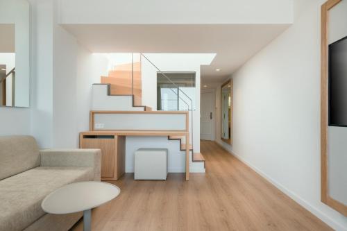 a living room with a staircase and a couch at Iberostar Selection Jardín del Sol Suites - Adults Only in Santa Ponsa