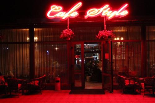 a restaurant with a neon sign above the door at Hotel Style BESSARABIA in Kiliya