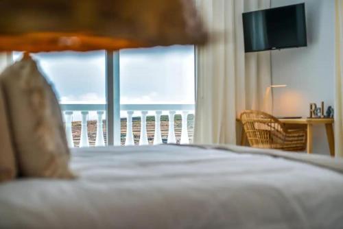 Ένα ή περισσότερα κρεβάτια σε δωμάτιο στο Las Nieves Suites