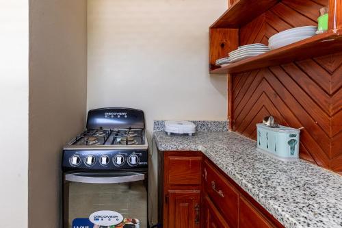 a kitchen with a stove and a counter top at Hotel Turístico Marian in Las Terrenas