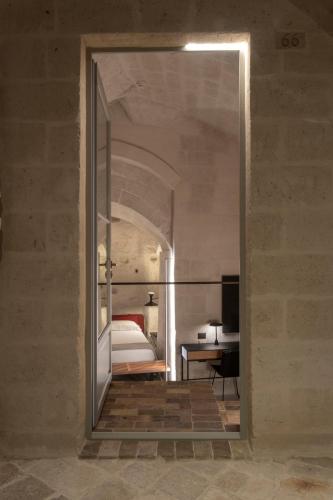 a bedroom with a bed and a desk in a room at PIANELLE RESORT in Matera