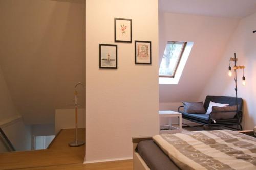 a bedroom with a bed and a chair in a room at Ferienhaus Haas - Am Heidschnuckenweg in Faßberg