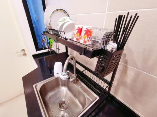 a kitchen sink with a drying rack next to it at Legoland 3min Lakeview HappyRainbowSuite 7Pax 2R2B in Nusajaya