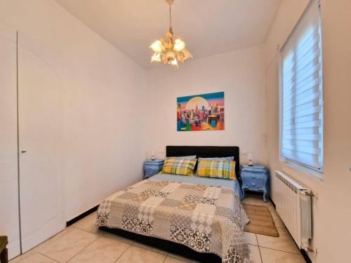 a bedroom with a bed and a chandelier at Ela dream in La Spezia