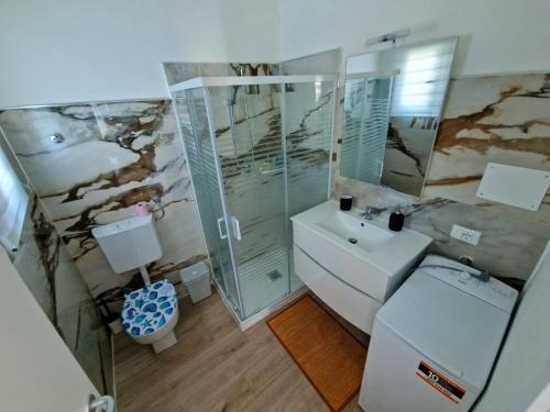 uma casa de banho com um lavatório, um chuveiro e um WC. em Ela dream em La Spezia
