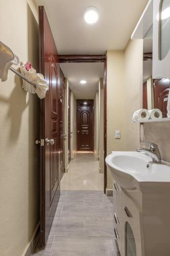a bathroom with a sink and a hallway at Hotel Turístico Marian in Las Terrenas