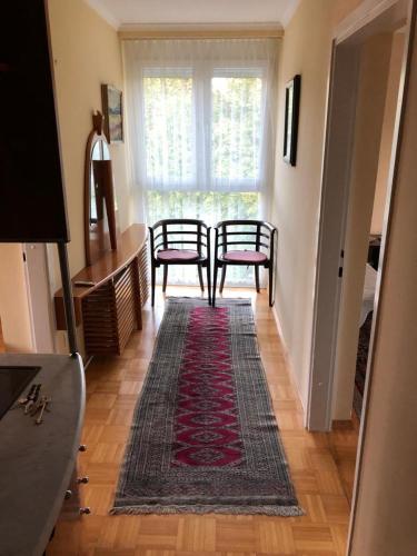 a living room with two chairs and a rug at Apartment Lucy, Bled in Bled