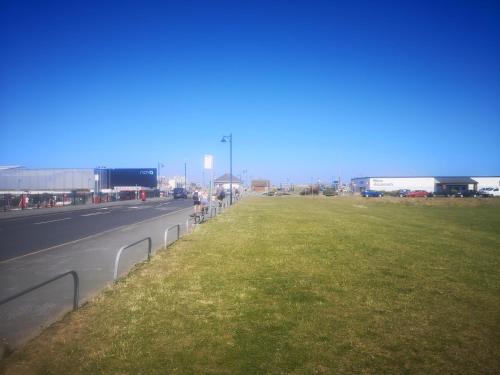 a highway with a grass field next to a road at VALE VIEW APARTMENT, Prestatyn, North Wales - a stylish, dog-friendly holiday let just a 5 min walk to beach & town! in Prestatyn