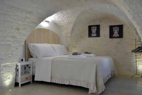 een slaapkamer met een bed in een stenen muur bij Attico Cinquantasei in Cisternino