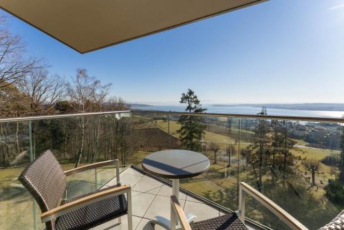 a balcony with chairs and a view of the ocean at Parkhotel St.Leonhard in Überlingen