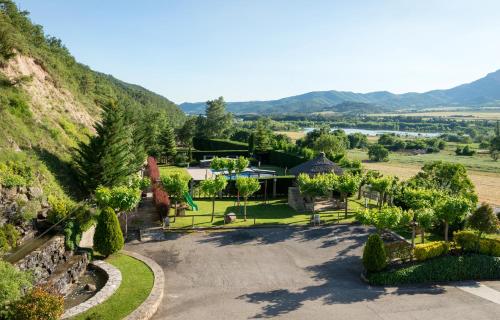 an aerial view of a house with a mountain at Hotel Restaurant Cal Petit in Oliana