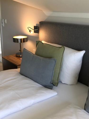 a bed with two pillows on top of it at Gästehaus Muhl in Strukkamp auf Fehmarn