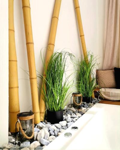 a room with three potted plants and bamboo poles at Atlantis Boutique City Hotel in Rhodes Town