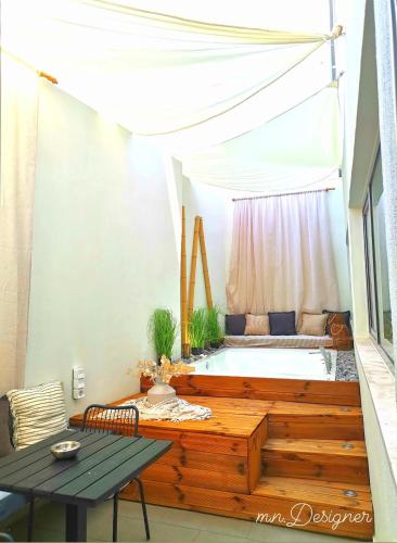 a room with a bath tub and a table at Atlantis Boutique City Hotel in Rhodes Town
