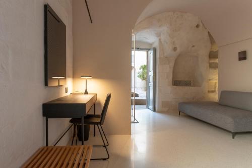 a room with a desk and a bed and a couch at PIANELLE RESORT in Matera