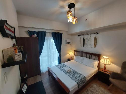 a small bedroom with a bed and a window at 1 bedroom with balcony near airport in Mactan