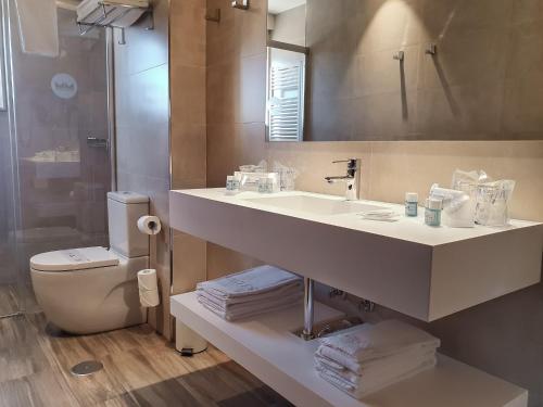 a bathroom with a sink and a toilet and a mirror at Montemar in Llanes