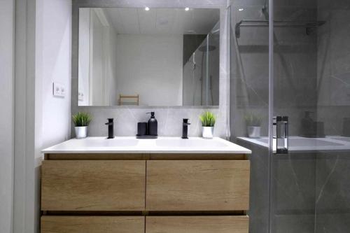 a bathroom with a white sink and a shower at Mike House Alójate en el corazón de Zaragoza in Zaragoza