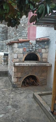 an outdoor brick oven with a fire place at Magnolia Traditional Stone House in Vamvakou in Vamvakoú