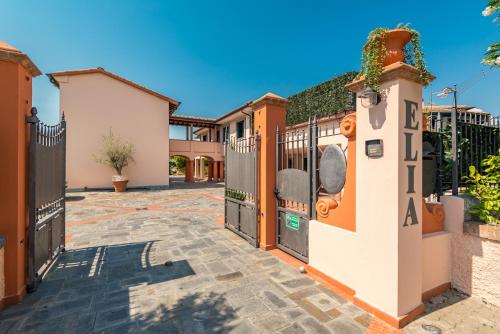 a gate in a driveway with a fence at Hotel la Pietra restaurant in Fosdinovo
