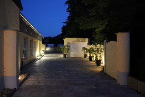 a walkway leading to a building at night at Hotel/Pension Rast& Ruh in Zodel