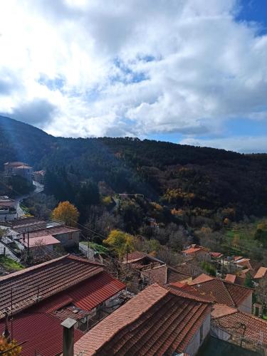 a view of a town with a mountain in the background at Magnolia Traditional Stone House in Vamvakou in Vamvakoú