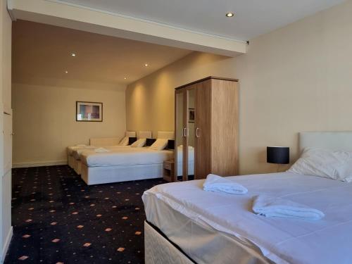 a hotel room with two beds and a cabinet at Park View House in Edinburgh