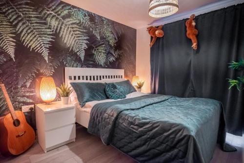 a bedroom with a bed and a guitar in it at Forest Home in Northampton